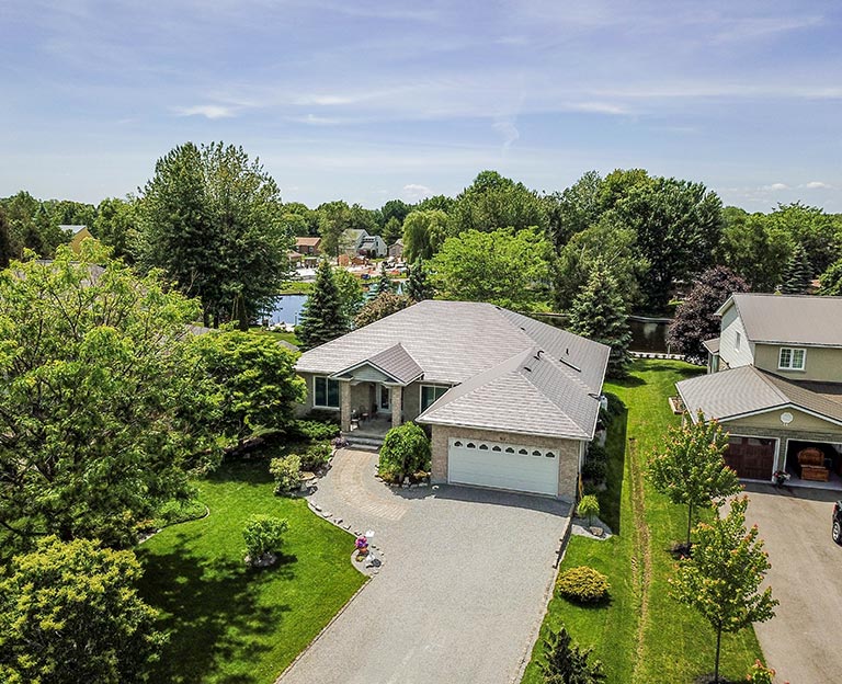 Residential home with pond and landscaped yard