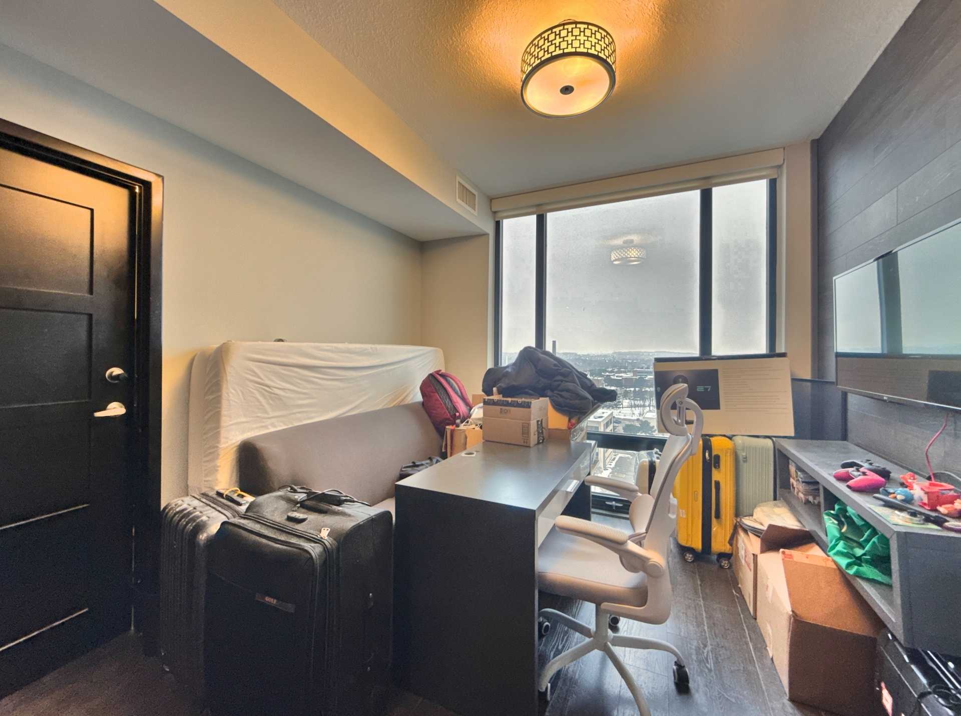 Cluttered bedroom with boxes and furniture