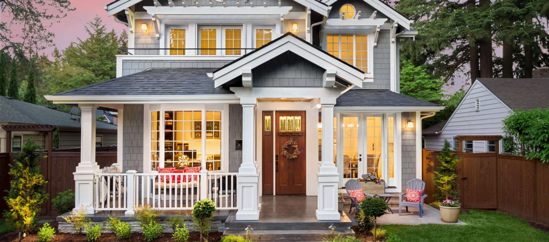 Stone and stucco home with manicured lawn