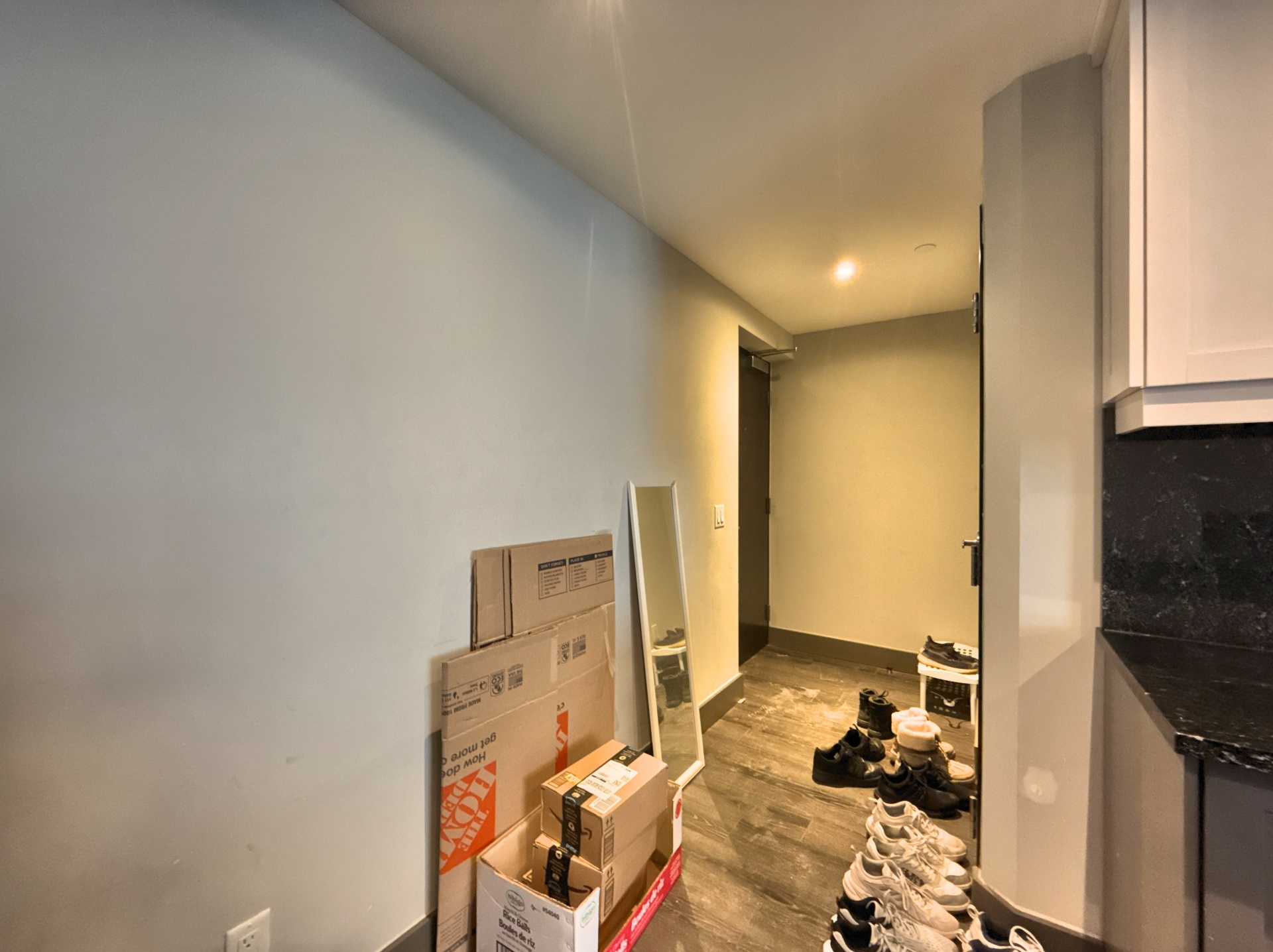 Cluttered hallway with boxes and personal items