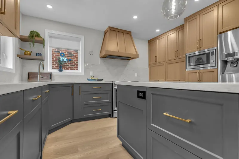 Kitchen with oak range hood and brass pulls — Burlington real estate photography by Estate Shutter