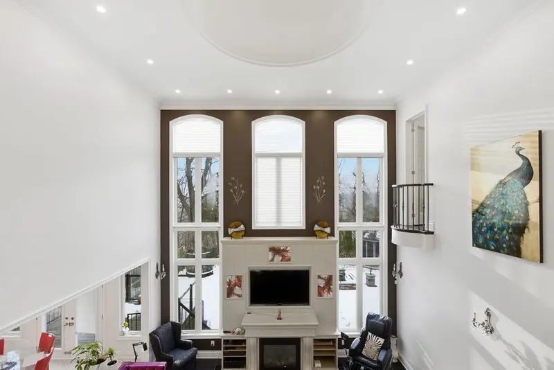 Double-height great room with arched windows — Pickering real estate photography by Estate Shutter