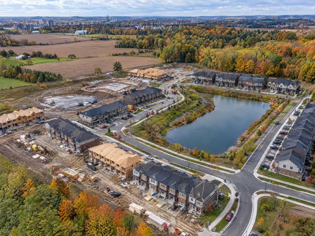 Aerial view of a townhome subdivision under construction on the edge of Guelph in autumn