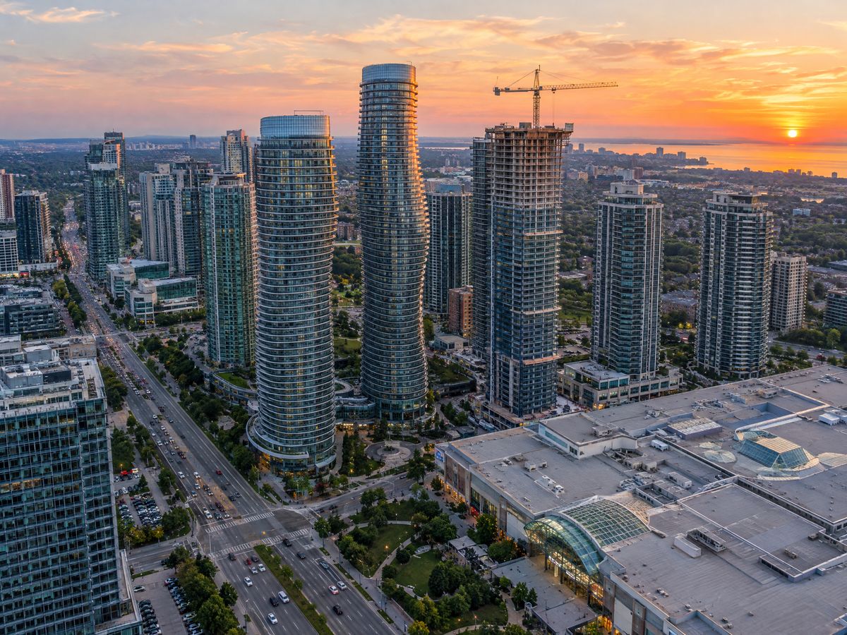 Aerial view of Mississauga City Centre towers at sunset with one tower under construction