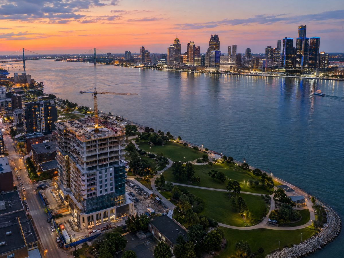 Aerial view of a building under construction on the Windsor riverfront with Detroit across the river