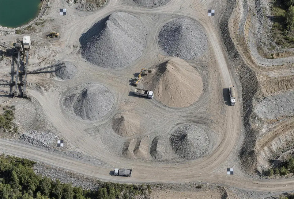 Aerial view of an aggregate pit with stockpiles, haul roads and ground control targets