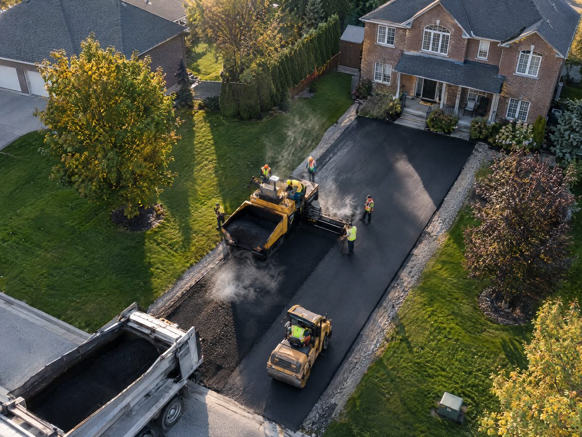 Aerial photo of an asphalt crew paving a driveway