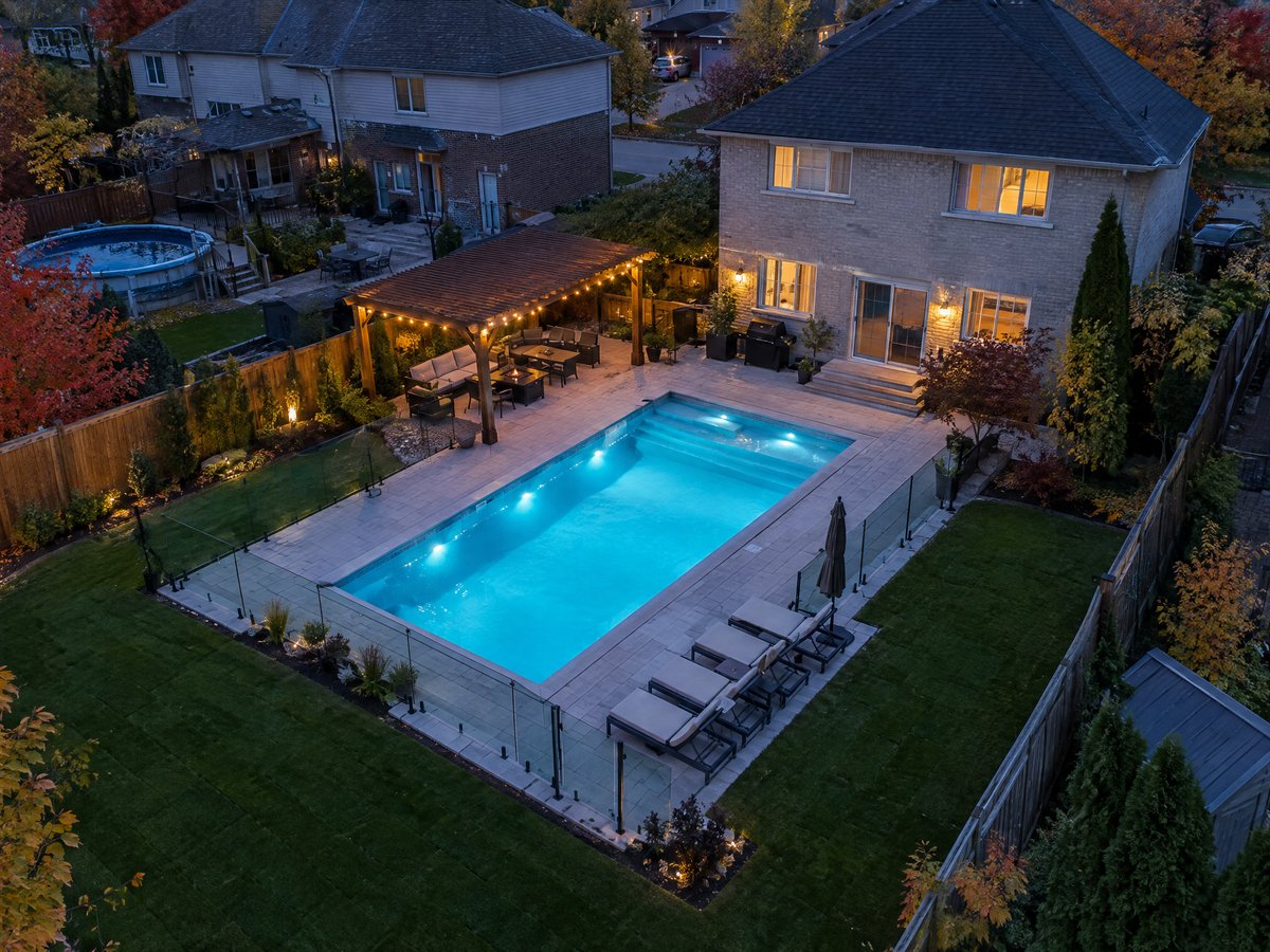 Aerial twilight photo of a finished inground pool and patio