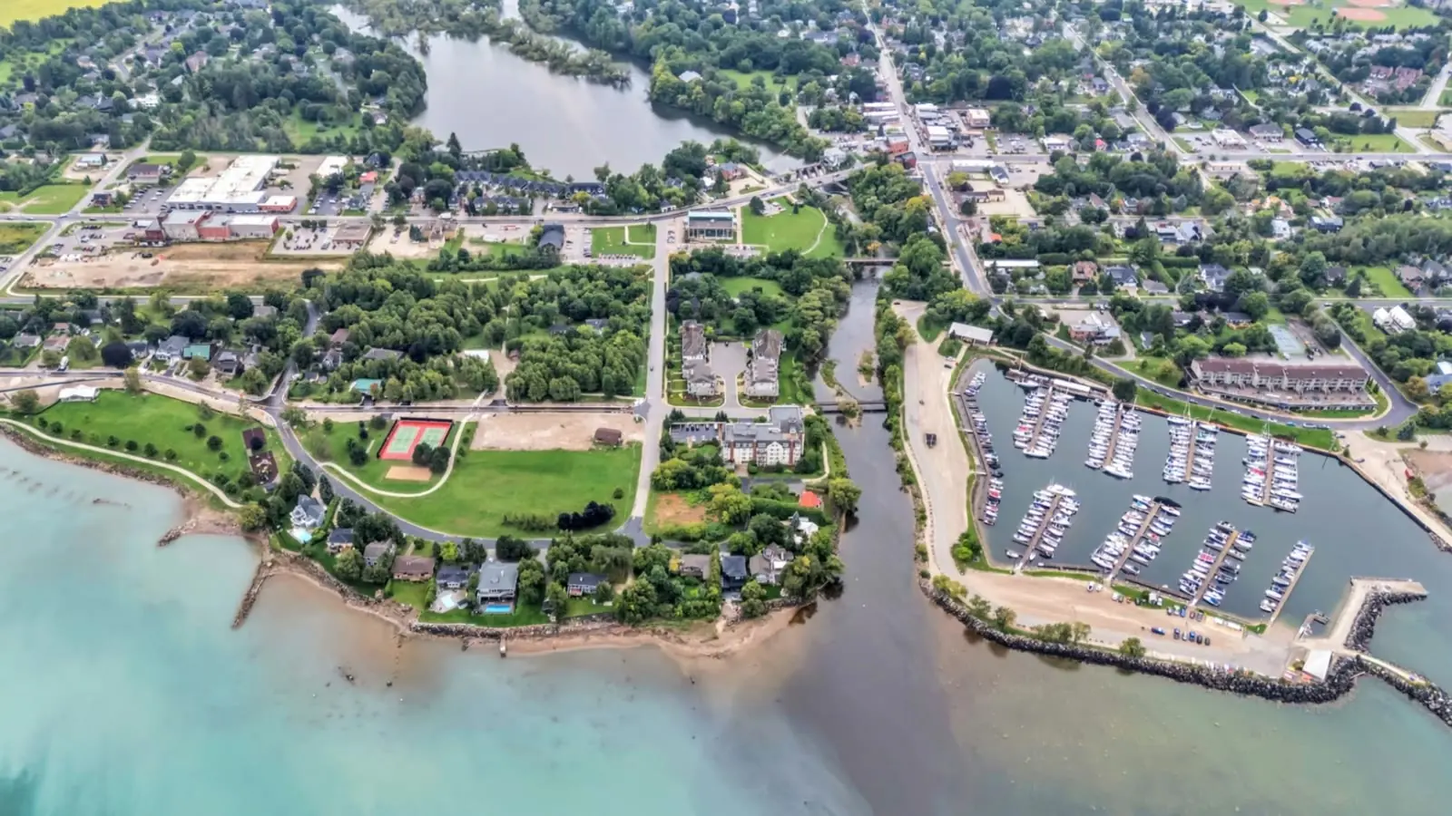 Aerial pass over a Georgian Bay marina, shoreline and town in the Blue Mountains, Ontario — Estate Shutter drone footage