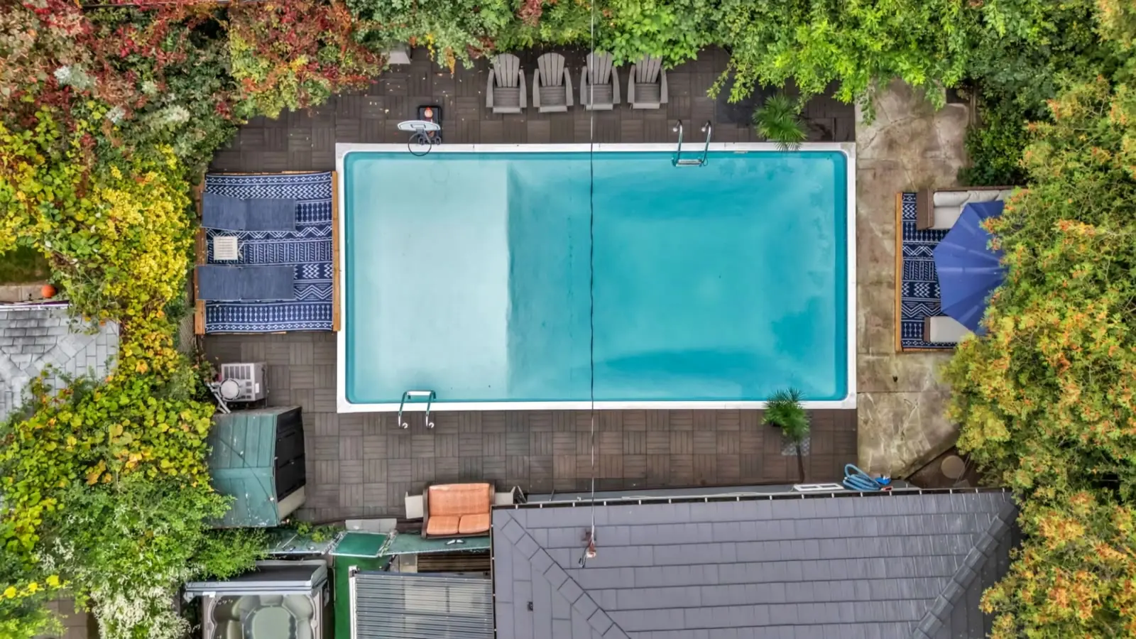 Top-down drone view of a backyard pool and deck in Pickering