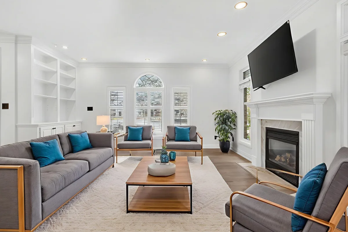 The same London living room, digitally staged with sofas and a coffee table