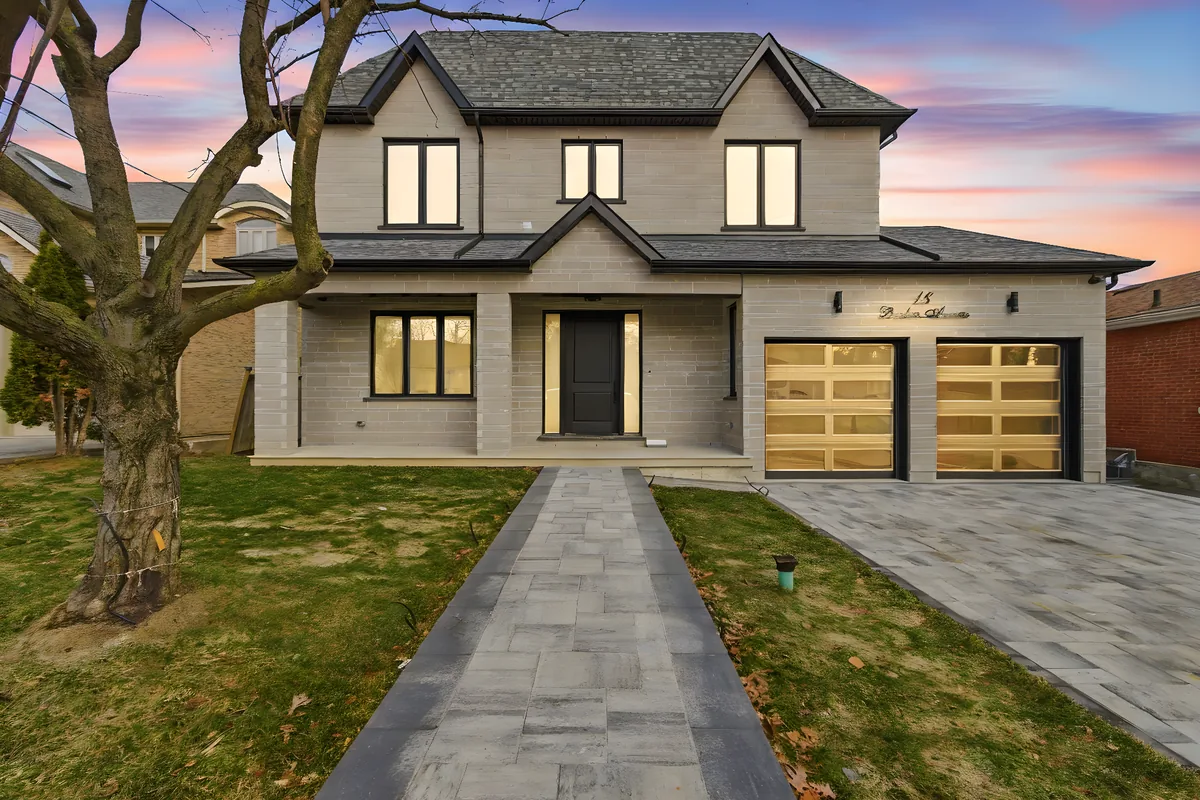 The same Toronto home edited to dusk, windows and garage lit warm