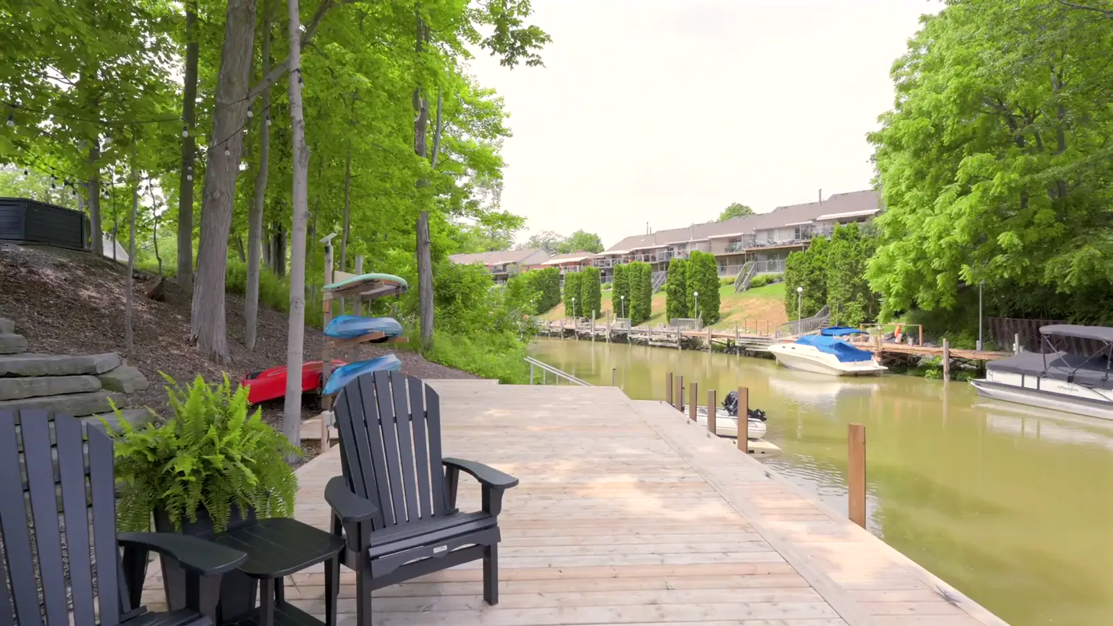 Aerial over private boat docks on the river at Grand Bend — drone real estate photography by Estate Shutter