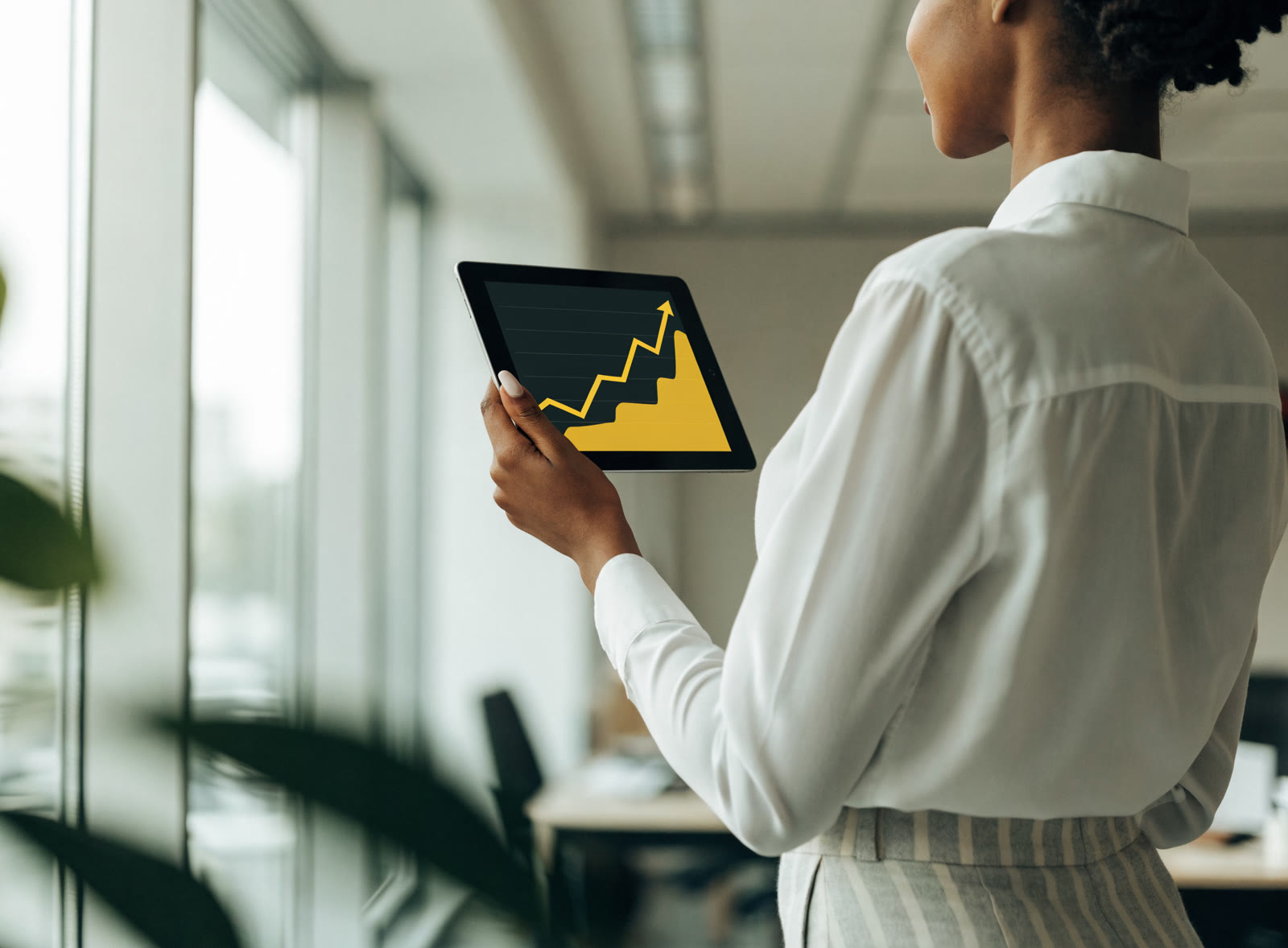 An agent reviewing an upward marketing chart on a tablet