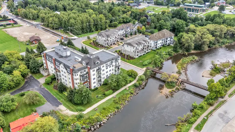 Waterfront condos, a river mouth and parkland in the Blue Mountains — drone photo by Estate Shutter, Blue Mountains, ON