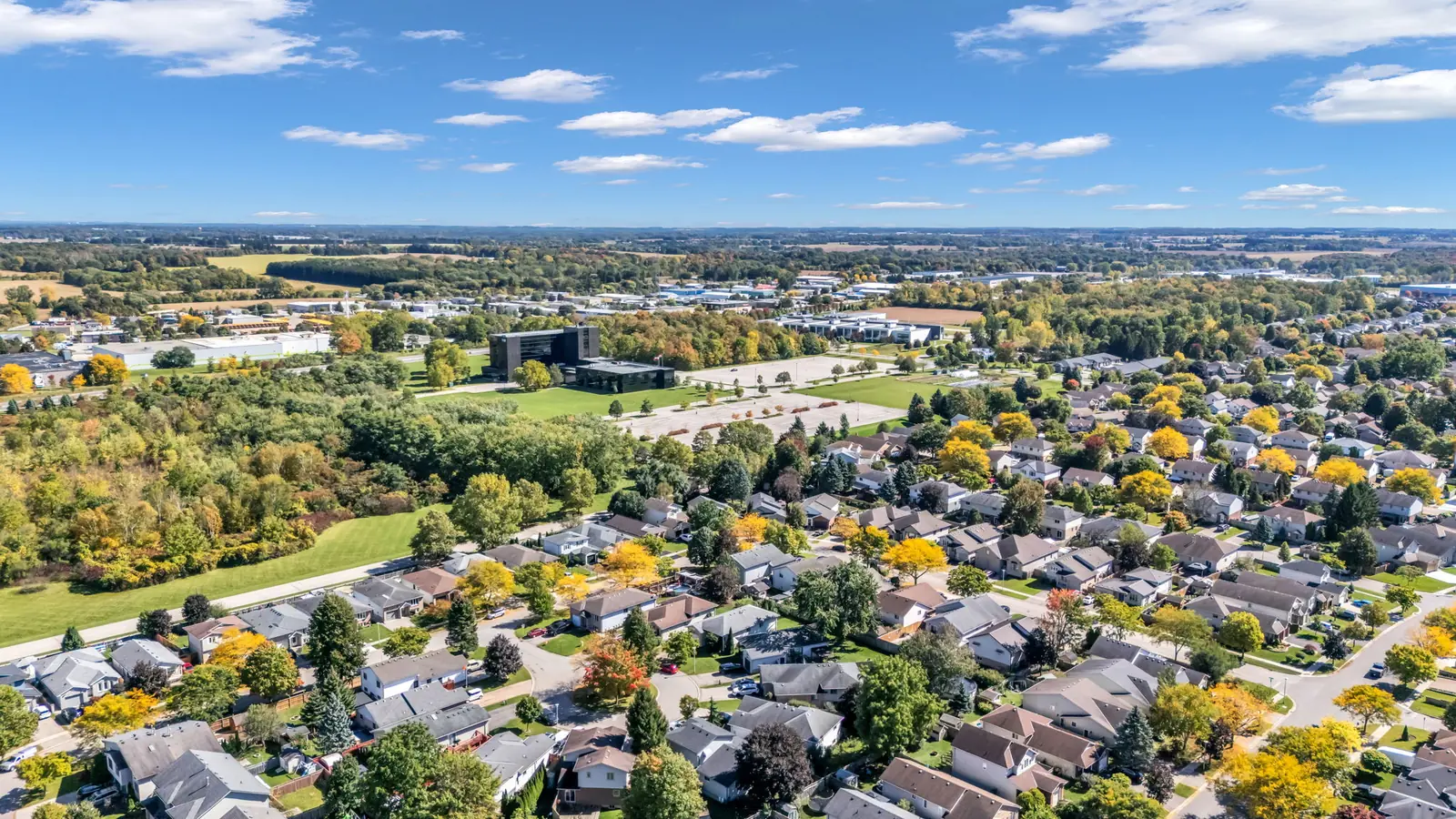 High aerial over London, Ontario at daybreak, the city spreading to the horizon — drone photo by Estate Shutter