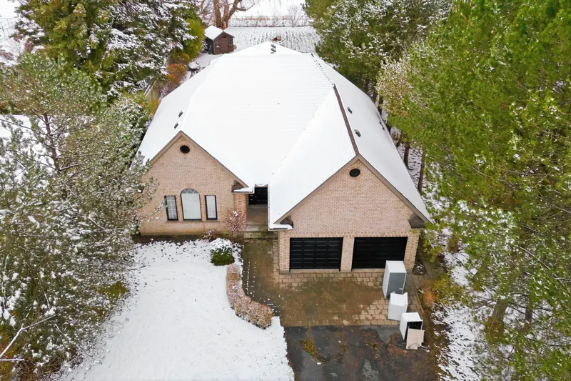 Winter aerial of a bungalow on a treed lot — London real estate photography by Estate Shutter