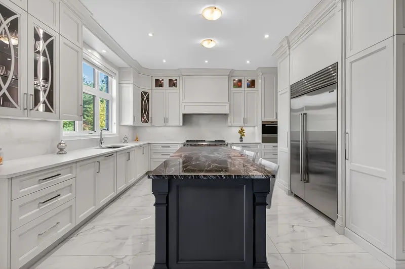 Kitchen with built-in fridge and stone island — Vaughan real estate photography by Estate Shutter
