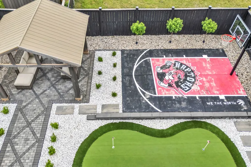 Top-down aerial of a backyard with putting green — Woodstock real estate photography by Estate Shutter