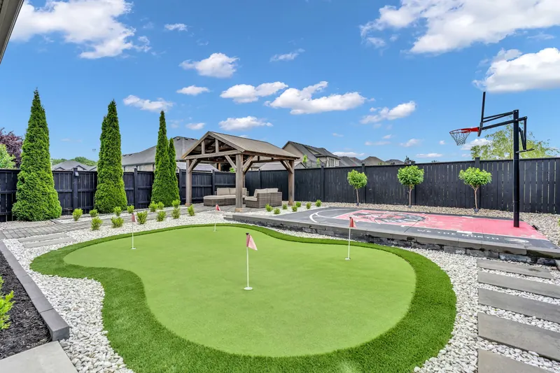 Backyard putting green and covered patio — Woodstock real estate photography by Estate Shutter