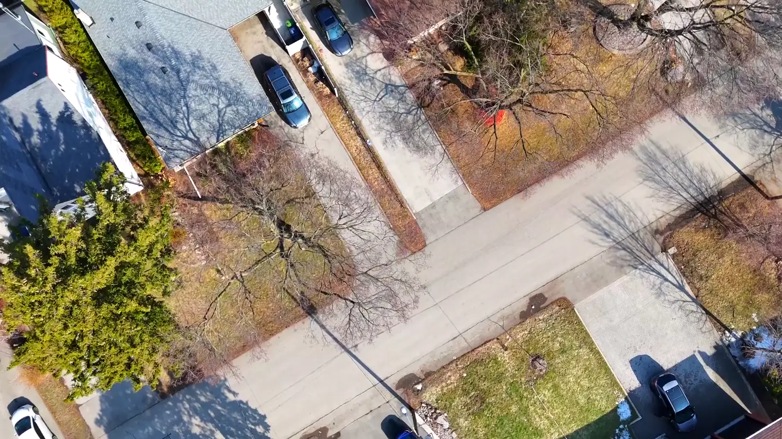 Aerial over a Toronto street ending at a modern custom home — drone real estate photography by Estate Shutter