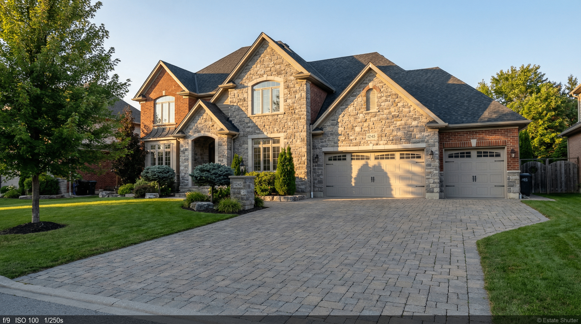 Luxury residential real estate photography Ancaster Hamilton - stone facade custom home with landscaping
